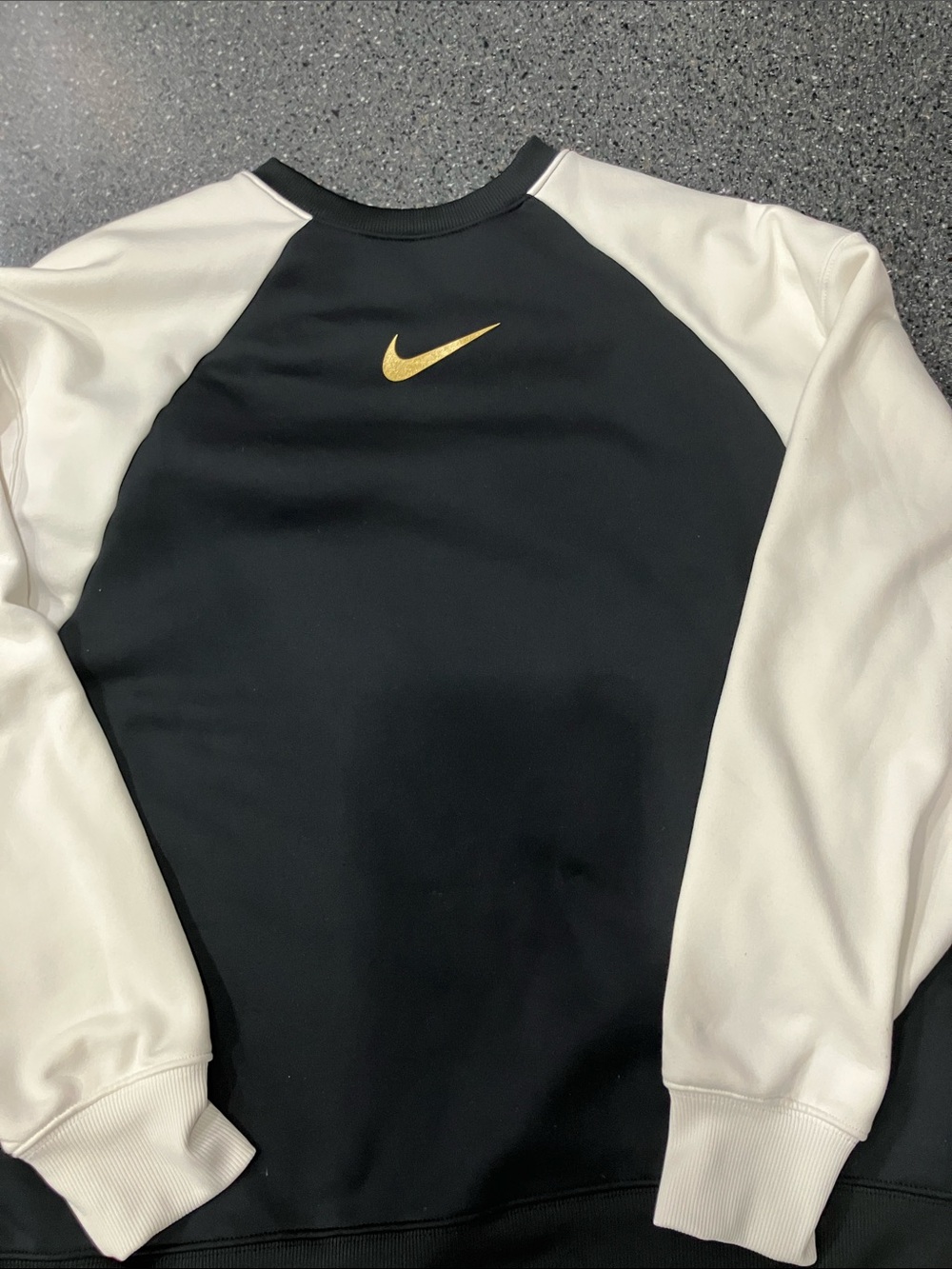 Nike Black Crewneck Sweatshirt with White Sleeves and Gold Swoosh